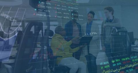 Team Collaborating Amidst Financial Data Projection in Office