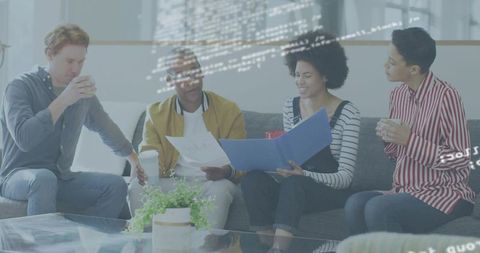 Diverse team reviewing documents with blue binder and code overlay in casual lounge