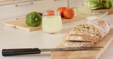Rustic kitchen counter with sliced bread and fresh ingredients