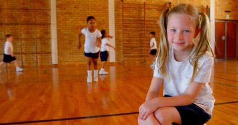 Energetic School Parcitapating Kids in Gymnasium Activities