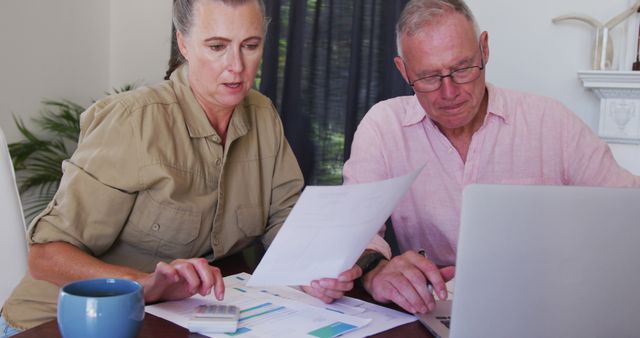 Caucasian senior couple with laptop calculating finances together at home - Download Free Stock Photos Pikwizard.com