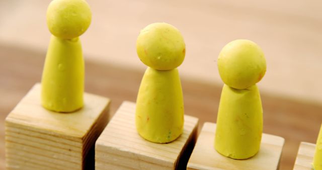 Yellow Clay Figures on Wooden Blocks - Download Free Stock Images Pikwizard.com