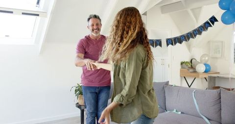 Joyful Dancing Couple Celebrating Birthday at Home