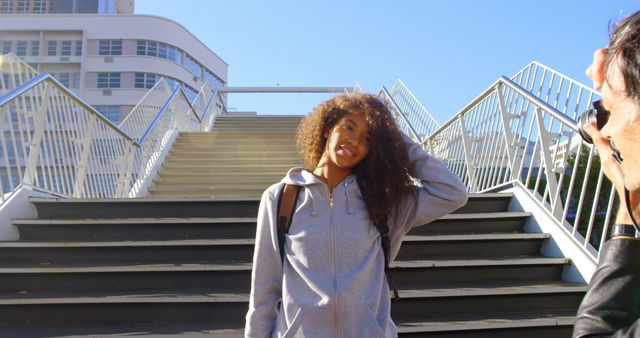 Smiling Teen Girl Posing on Urban Staircase in Bright Sunlight - Download Free Stock Images Pikwizard.com