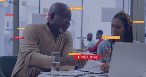 Diverse Professionals Engaged in Report Discussion with Technology Overlays