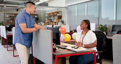 Colleagues Celebrating Birthday with Cake and Balloons at Office
