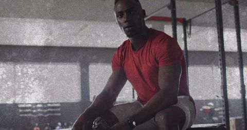 Athletic Man Lifting Dumbbell in Gym for Strength Training