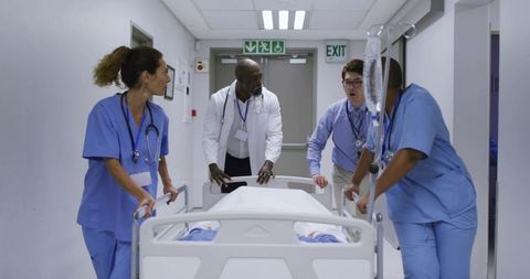 Medical team transporting patient on gurney through hospital corridor during emergency