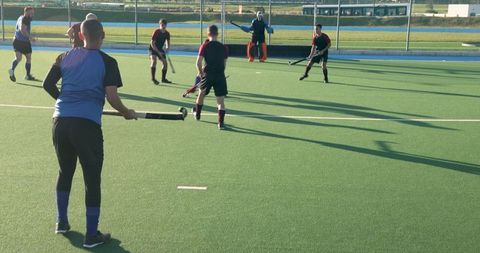Intense Field Hockey Match with Male Players