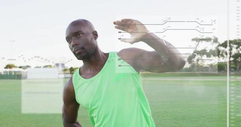 Male athlete stretching, raising arm on sports field with hud performance analytics overlay