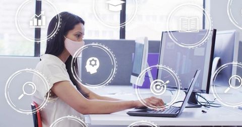 Businesswoman in Mask Working on Laptop Amid Digital Icons