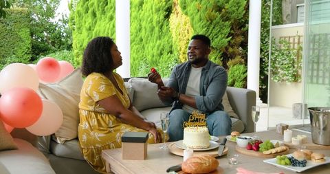 Mature Couple Celebrating Birthday on Elegant Patio Setting
