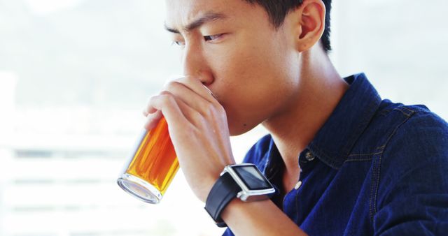 Young Man Drinking Tea and Wearing Smartwatch - Download Free Stock Images Pikwizard.com