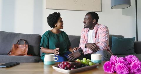 Friends Sharing Conversation Over Coffee in Cozy Living Room