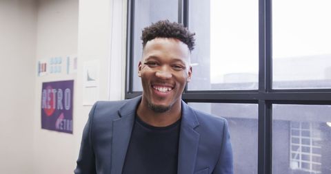 Happy professional businessman in office setting