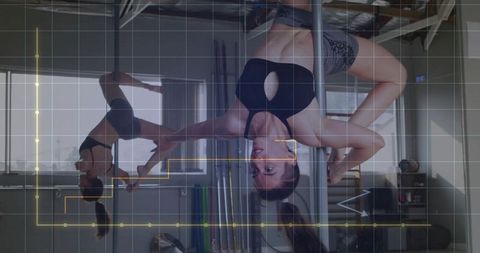 Woman Performing Advanced Pole Exercise in Gym