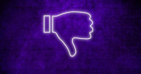 Neon thumbs down symbol glowing on dark background