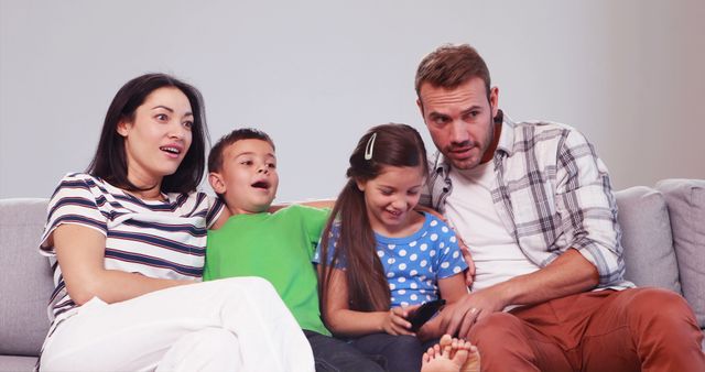 Family Watching TV on Couch with Excited Reactions - Download Free Stock Images Pikwizard.com