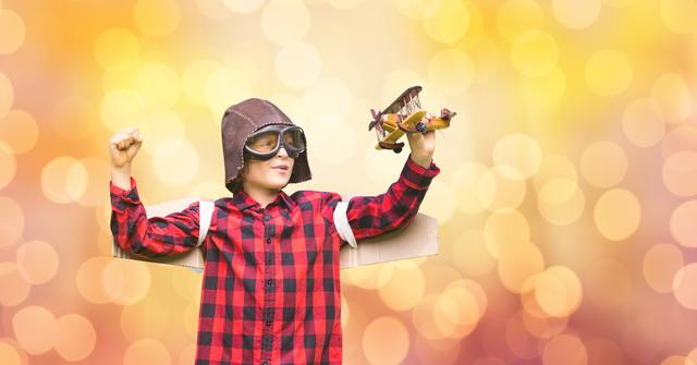 Digital composite of Little boy wearing helmet while flying helicopter over bokeh