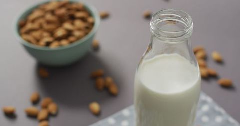 Almond Milk Bottle Beside Fresh Almonds on Grey Surface - Download Free Stock Images Pikwizard.com