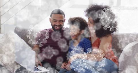 Happy family with laptop at home surrounded by illustrated swirls