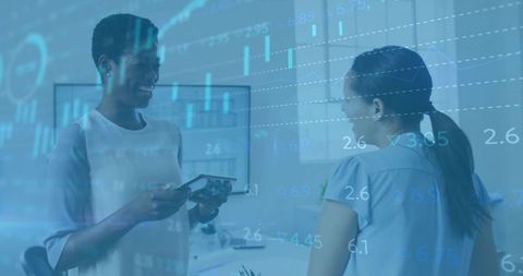 Two Businesswomen Analyzing Digital Data in Modern Office Environment