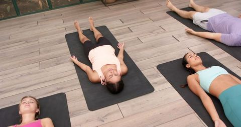 Relaxing Group Yoga Class in End-of-Session Savasana Pose