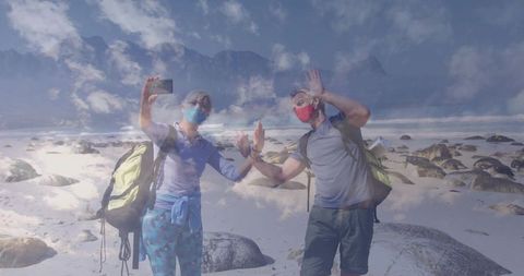 Hiking Friends Taking Selfie Wearing Masks by Scenic Mountain Beach