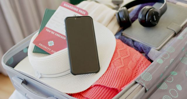 Packing Suitcase with Smart Phone, Headphones, and Boarding Pass - Download Free Stock Images Pikwizard.com