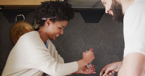 Happy Diverse Couple Preparing Meal Together in Modern Kitchen