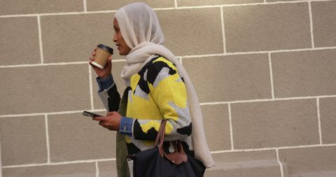 Urban Woman with Hijab Enjoying Coffee and Phone - Download Free Stock Images Pikwizard.com