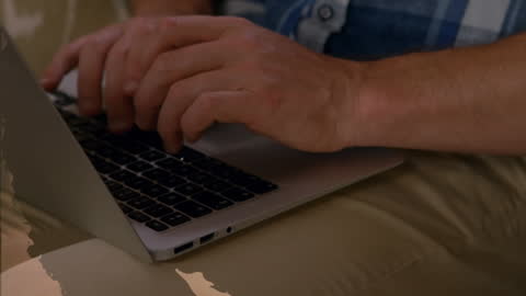 Close-up of Hands Typing on Laptop with Data Overlay