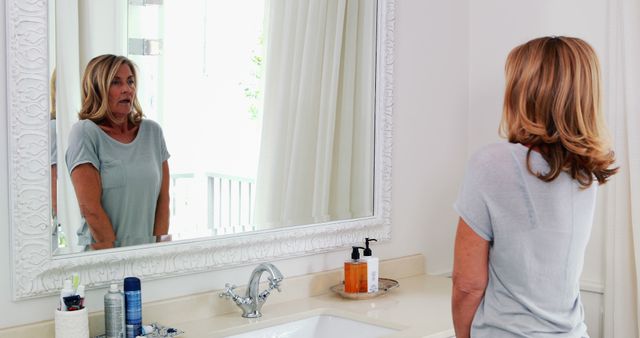 Mature Woman Reflecting in Bathroom Mirror at Home - Download Free Stock Images Pikwizard.com