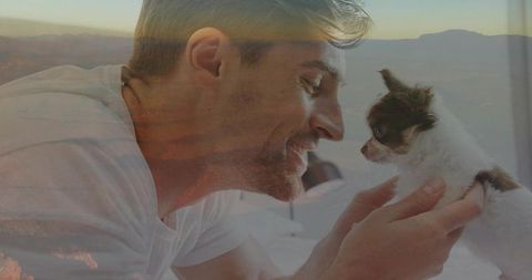 Joyful millennials celebrating bond with loving puppy at peaceful home