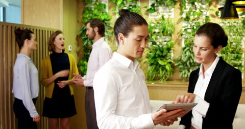 Diverse Professionals Collaborating in Eco-Friendly Modern Office