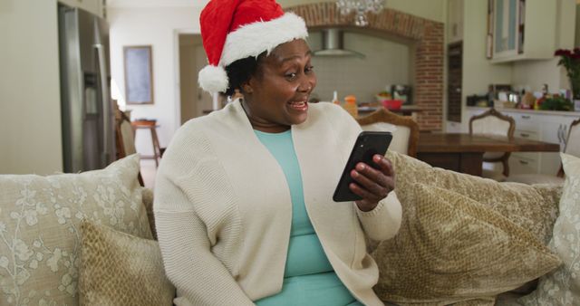 Excited Woman in Santa Hat Video Calling at Home During Christmas - Download Free Stock Images Pikwizard.com