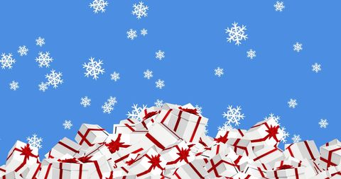 Snowflakes fall on christmas gifts blue background