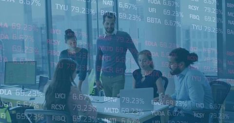 Team Collaborates on Data Analysis in Glass-Walled Boardroom