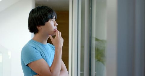 Thoughtful Student Gazing by Window in Contemplation