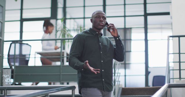 Professional Man Speaking on Phone in Office Environment - Download Free Stock Images Pikwizard.com