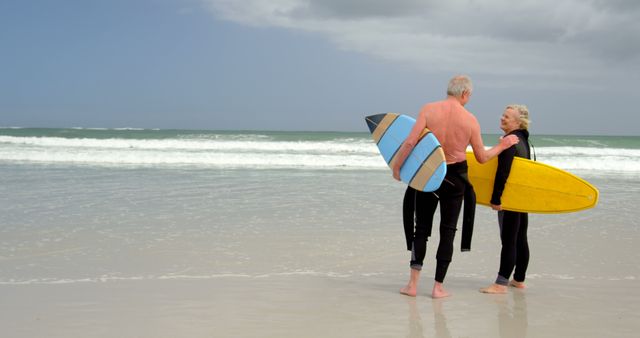 Senior Couple Surfing at Beach Holding Surfboards - Download Free Stock Images Pikwizard.com