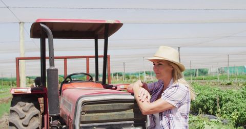 Smiling Female Farmer with Tractor in Organic Farm - Download Free Stock Images Pikwizard.com