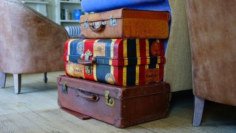 Vintage suitcase stack in cozy living room with armchair