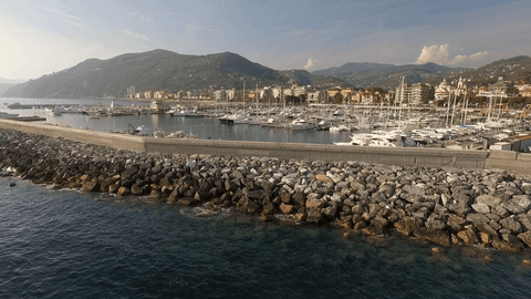 transparent coastal marina with rocky breakwater at scenic harborfront - Download Free Stock Videos Pikwizard.com