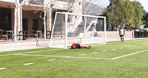 Young Soccer Players Practicing on Sunny Day Near Goalpost
