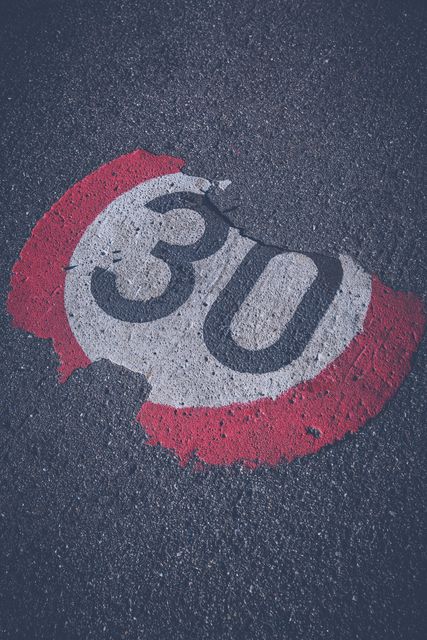 Faded 30 km/h Road Speed Limit Sign on Asphalt - Download Free Stock Images Pikwizard.com