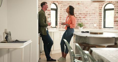 Couple Conversing in Modern Kitchen Interior