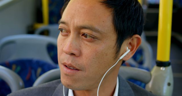 Man Commuting on Bus with Earphones, Close-Up - Download Free Stock Images Pikwizard.com