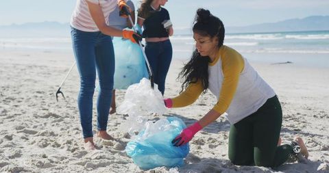 Diverse Female Volunteers Engaged in Beach Clean-up