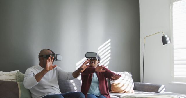 Couple Using Virtual Reality Headsets in Modern Living Room - Download Free Stock Images Pikwizard.com